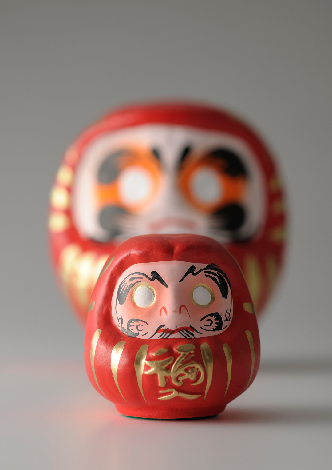 Antique red daruma figurine, representing determination and goal-setting in Japanese culture.